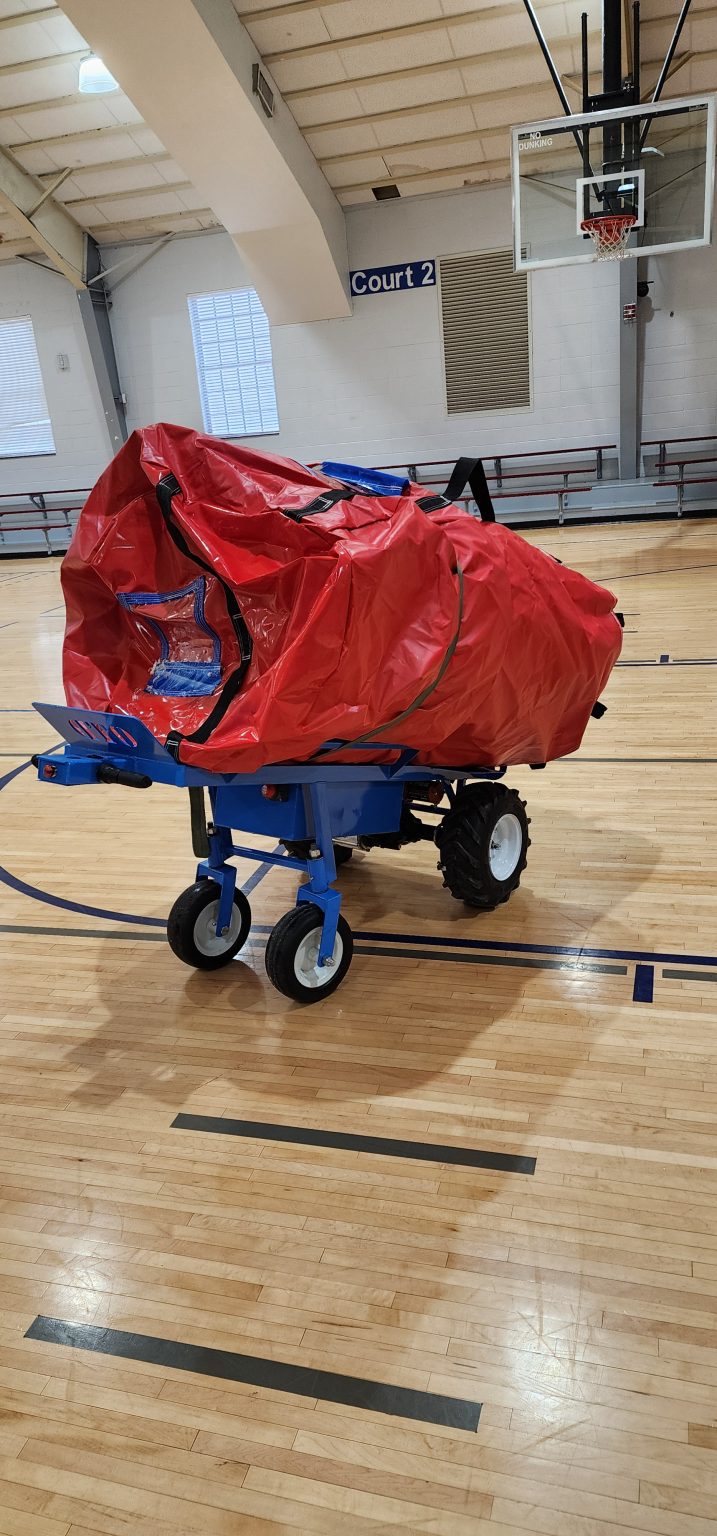 motorized dolly moving a bounce house. Using the photo to lure potential job seekers in for employment in Lancaster, KY