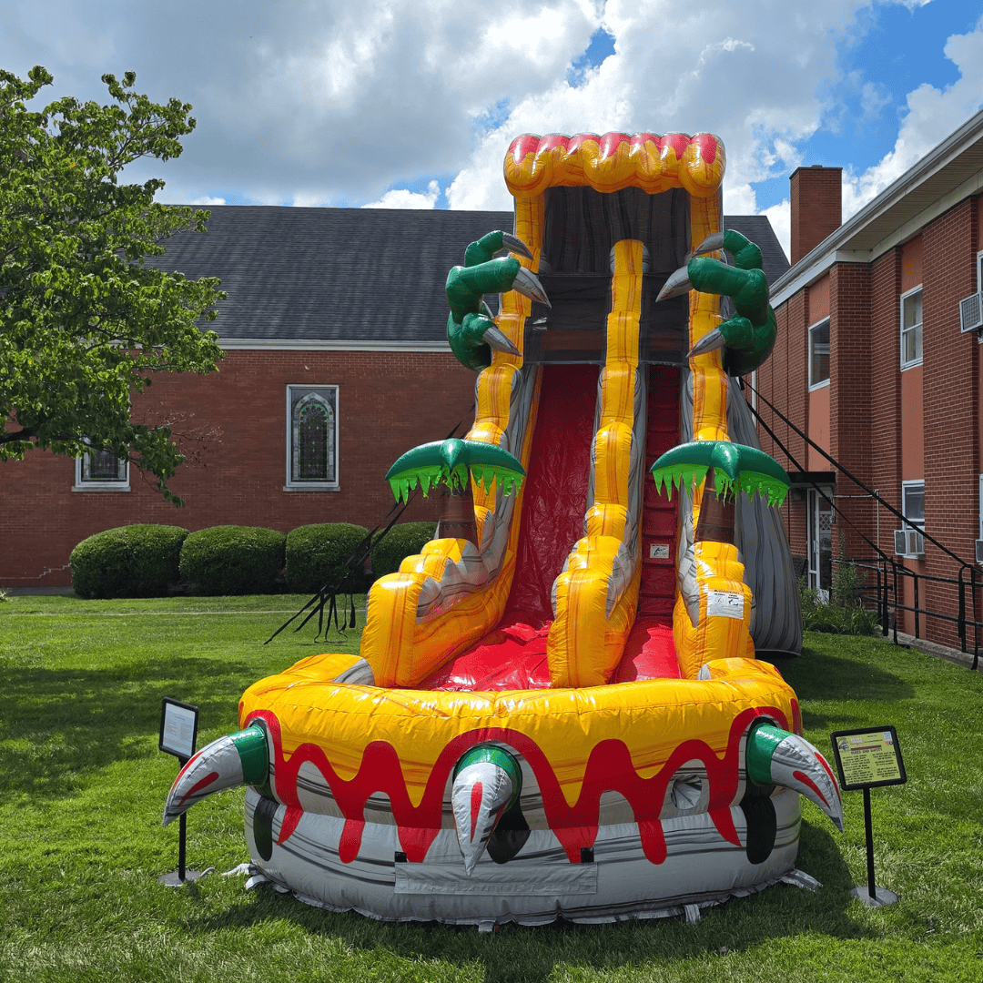 Kids running to play on an inflatable water slide rental in Harrodsburg, KY at a group event