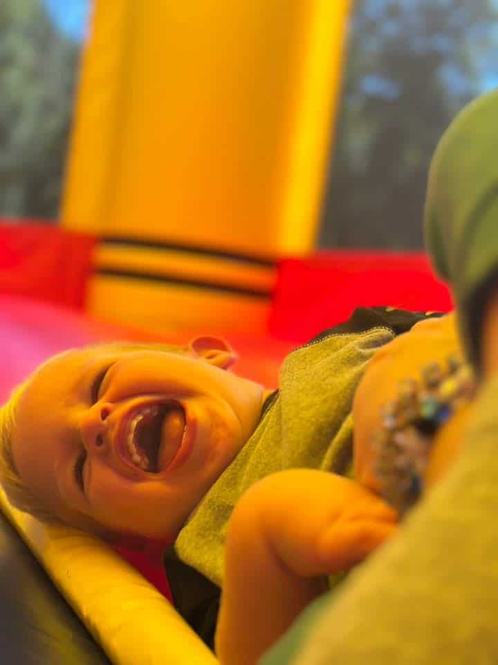 Young boy laughing on a bounce house rental in Central Kentucky