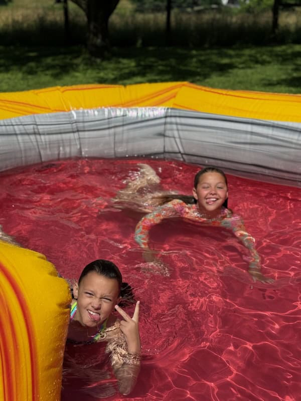 T-Rex inflatable water slide rental with kids in Central Kentucky from Backyard Responders