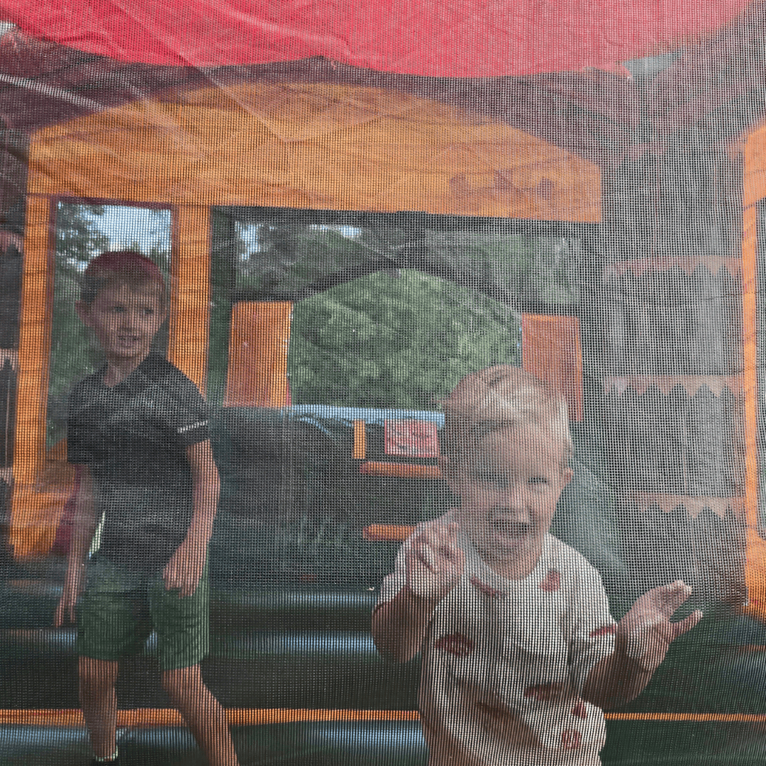 Parent supervising children safely during inflatable bounce house rental in Lexington KY