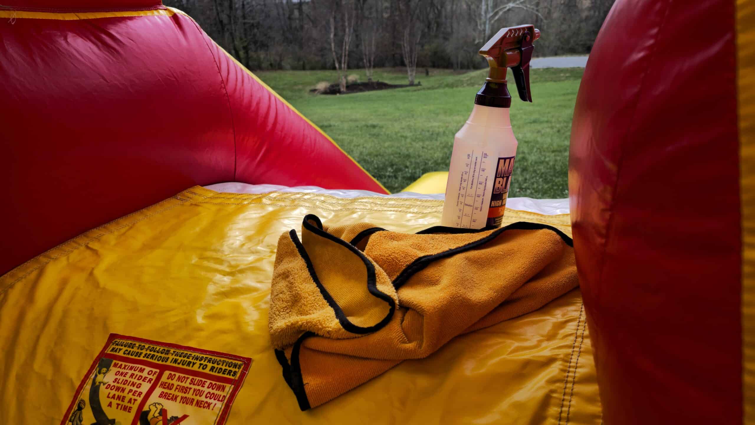 Cleaning and sanitizing inflatable bounce house rental between events in Lexington KY