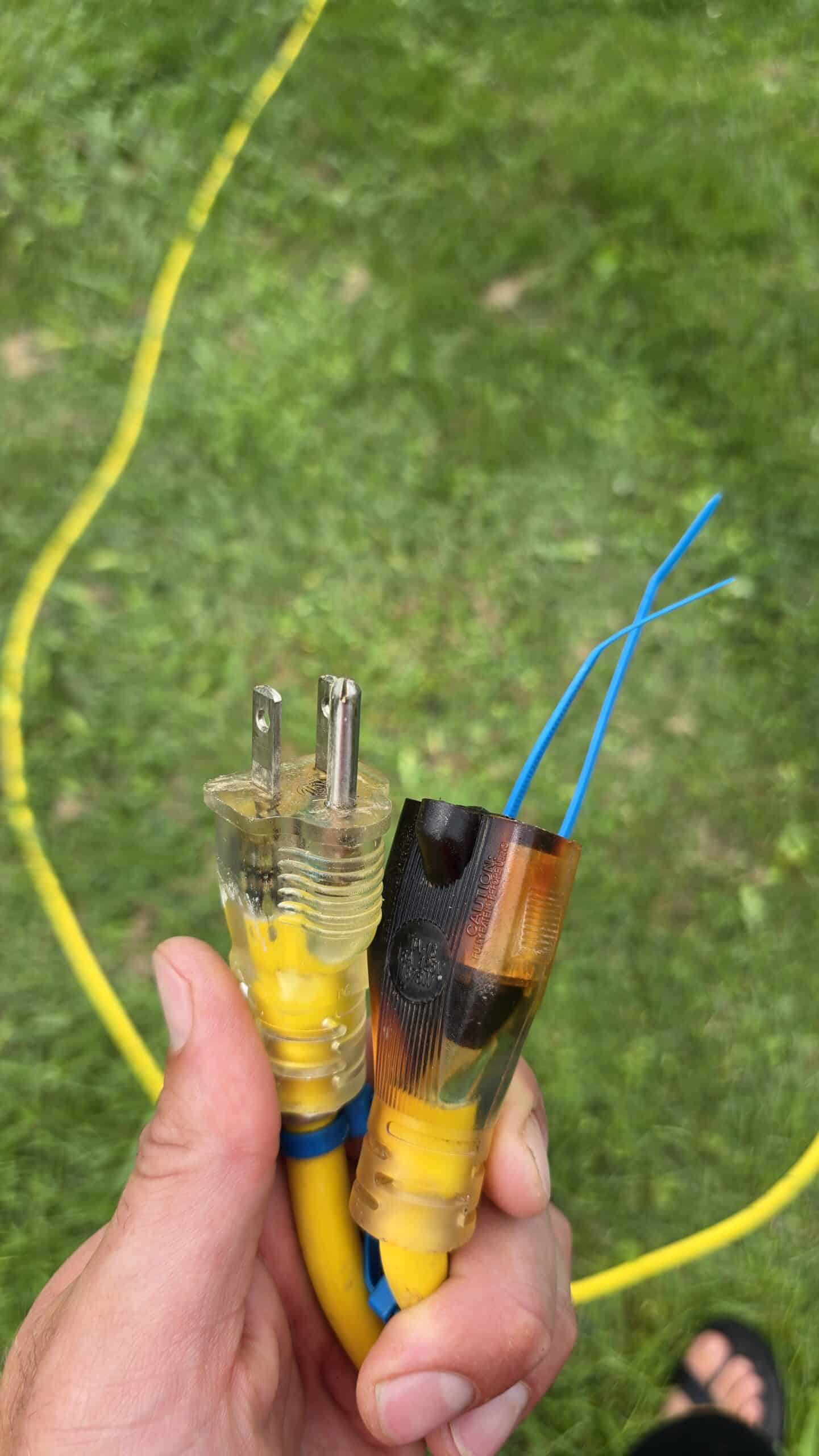 Damaged extension cord removed from inflatable bounce house rental service during inspection