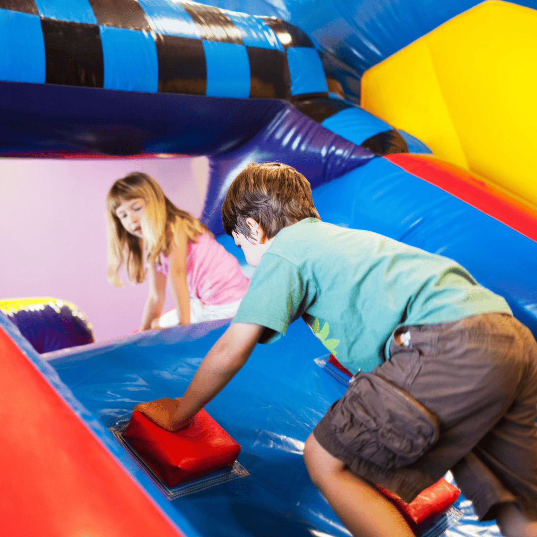 Inflatable obstacle course rental in Nicholasville, KY with kids climbing the steps for fast paced play in Jessamine County