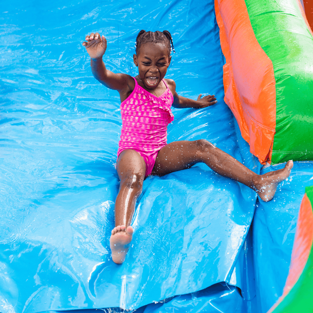 Girl on the water slide at a birthday party