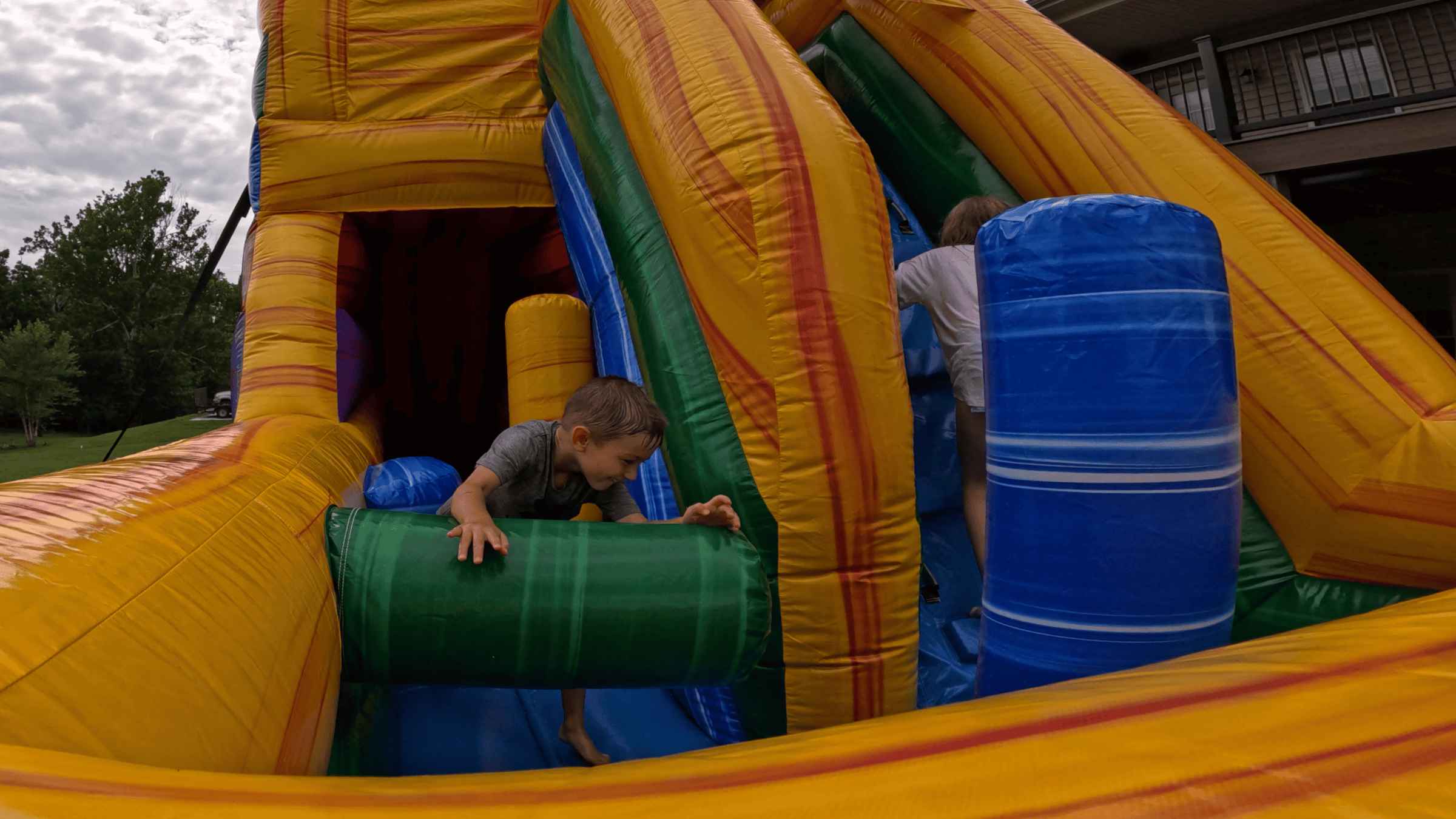 Boy on Castle Clash inflatable obstacle course — Backyard Responders