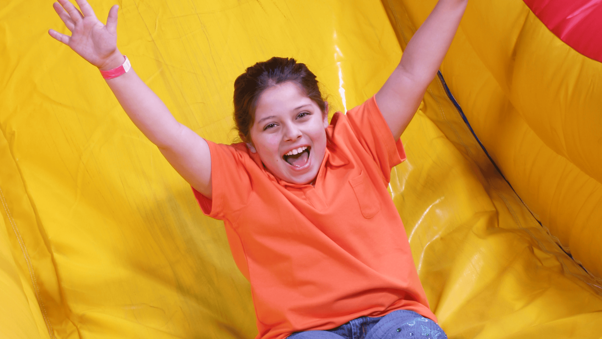 Kid going down an inflatable dry slide rental from Backyard Responders Central Kentucky