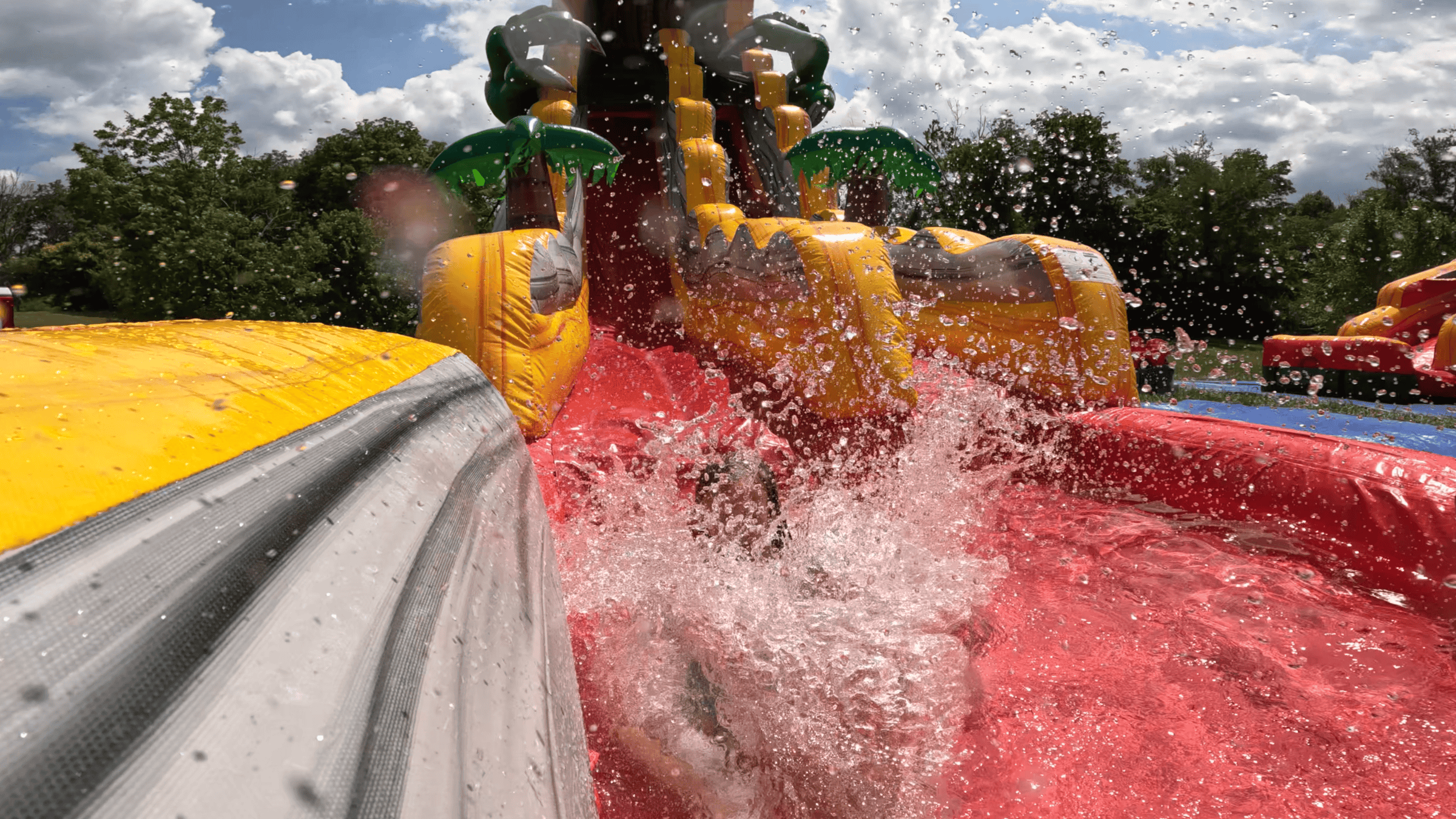 Big splash on the T-Rex water slide — party rentals Central Kentucky